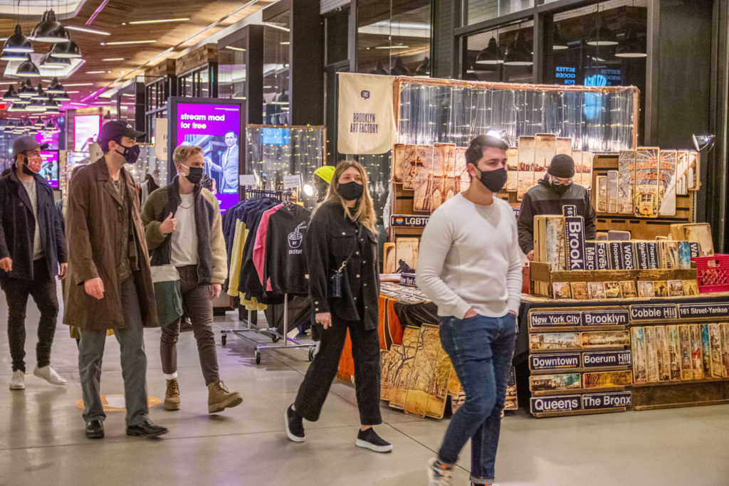 People with masks on walking through The Makers Market at City Point