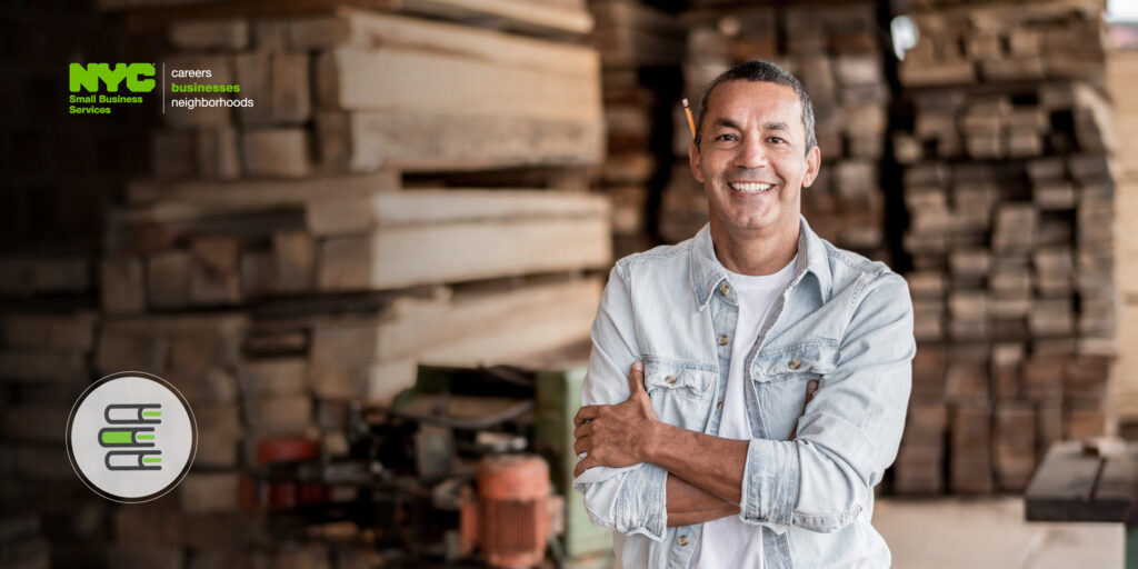 Smiling man standing in his industrial workplace